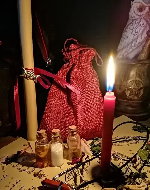 Red bag with candles and witchcraft herbs for magical rituals
