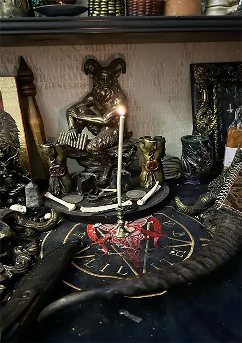 Ritual altar with metal items and statue used in dark magic