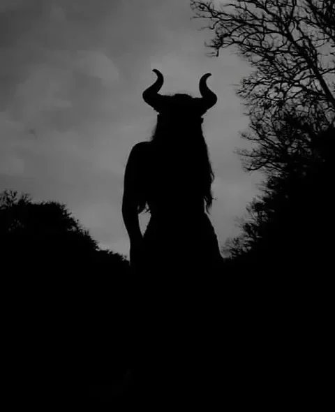Shadow silhouette of a woman with horns symbolizing Lilith spiritual pact witchcraft ritual