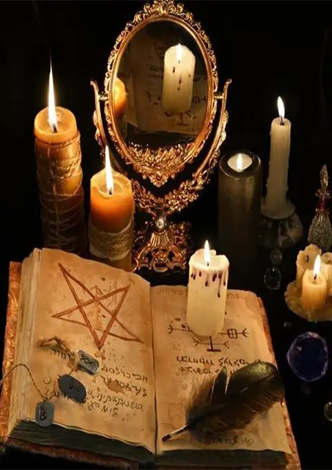 Witchcraft tools with a book, mirror, and candles