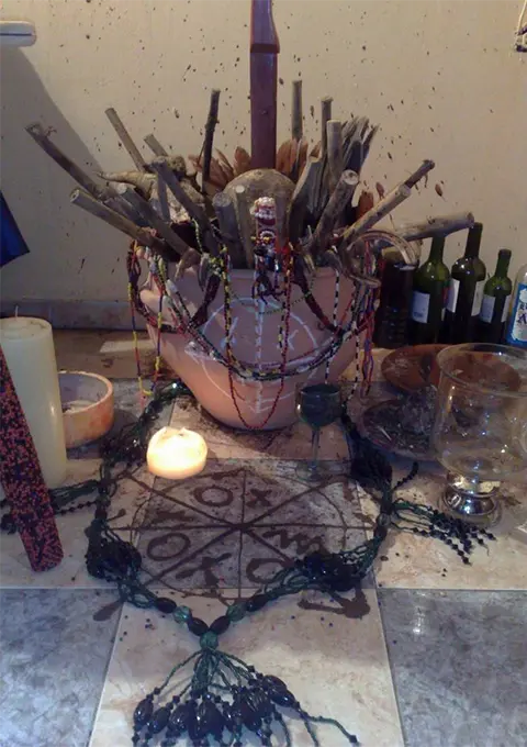Spiritual items used for voodoo and witchcraft removal rituals, including herbs, candles, and protective charms